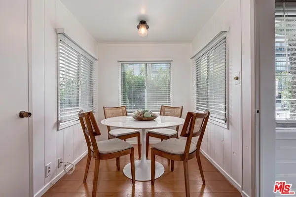 a view of a dining room with furniture and windows