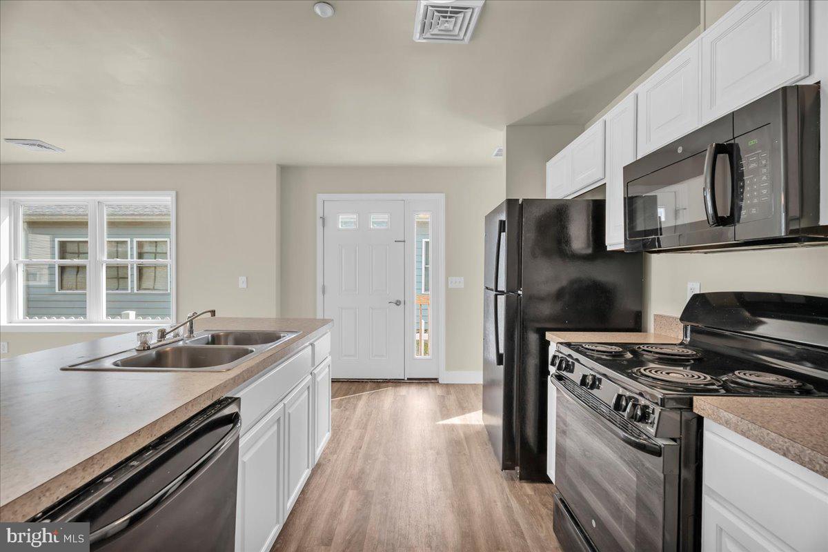 25 Eagle Street Bridgeton, NJ 08302 - Photo 11 of 24 a kitchen that has a sink stainless steel appliances and cabinets