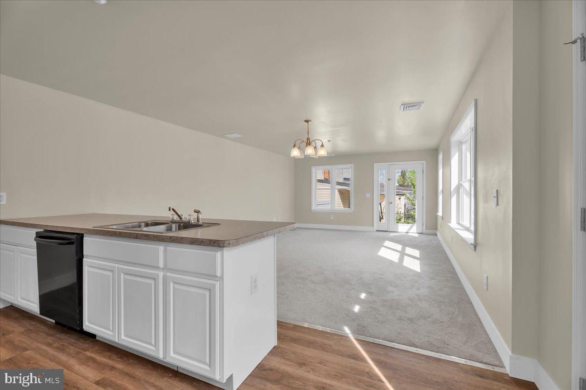 25 Eagle Street Bridgeton, NJ 08302 - Photo 13 of 24 a view of a kitchen cabinets a sink and dishwasher with wooden floor