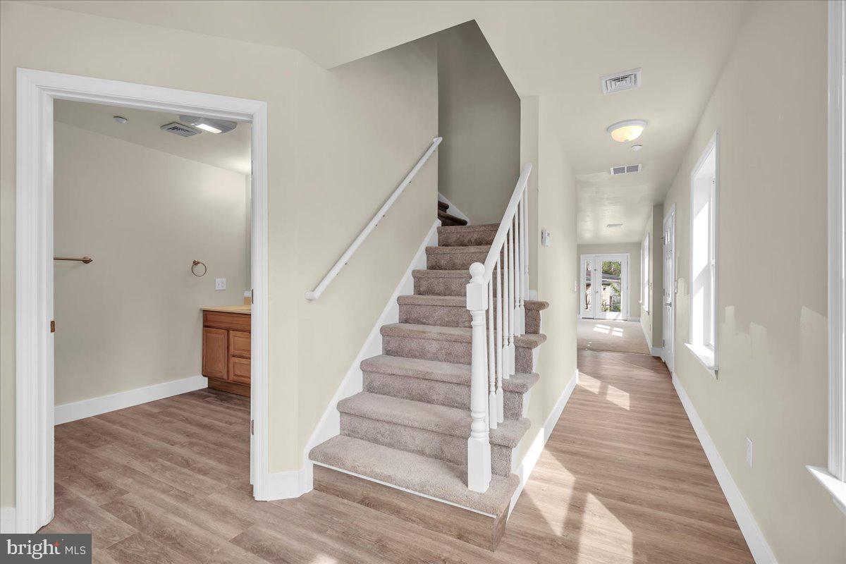 25 Eagle Street Bridgeton, NJ 08302 - Photo 6 of 24 a view of a hallway view with wooden floor and staircase
