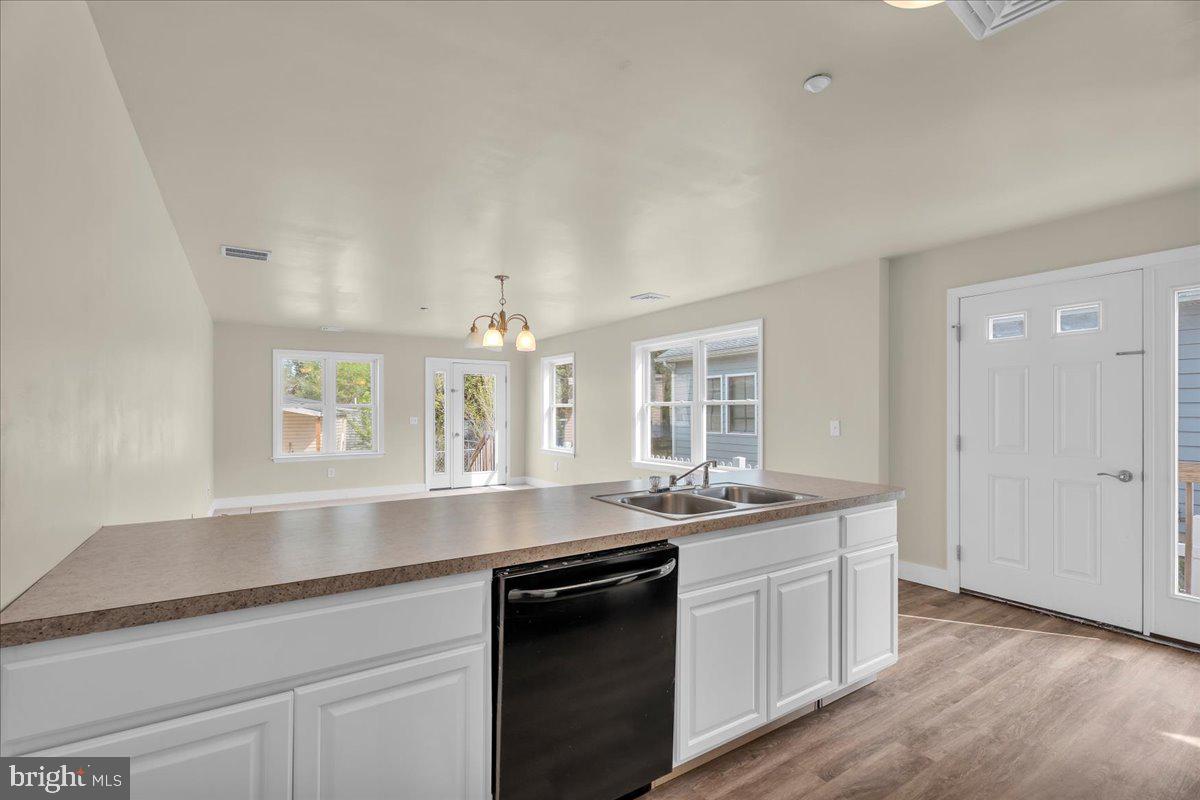 25 Eagle Street Bridgeton, NJ 08302 - Photo 10 of 24 a kitchen with stainless steel appliances granite countertop a sink and dishwasher with wooden floor