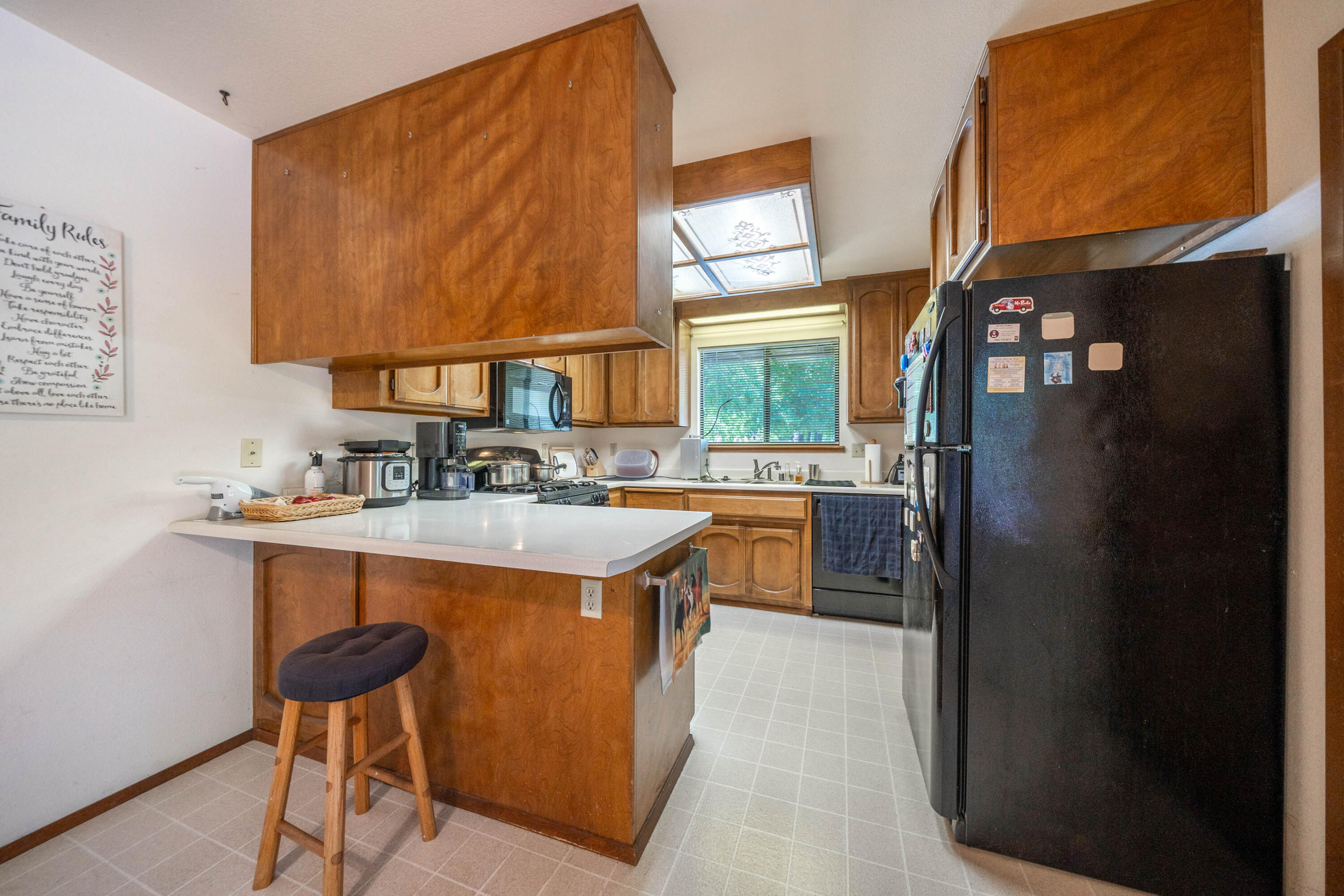 2285 Snow Lane Redding, CA 96003 - Photo 14 of 45 a kitchen with stainless steel appliances a sink stove and a refrigerator
