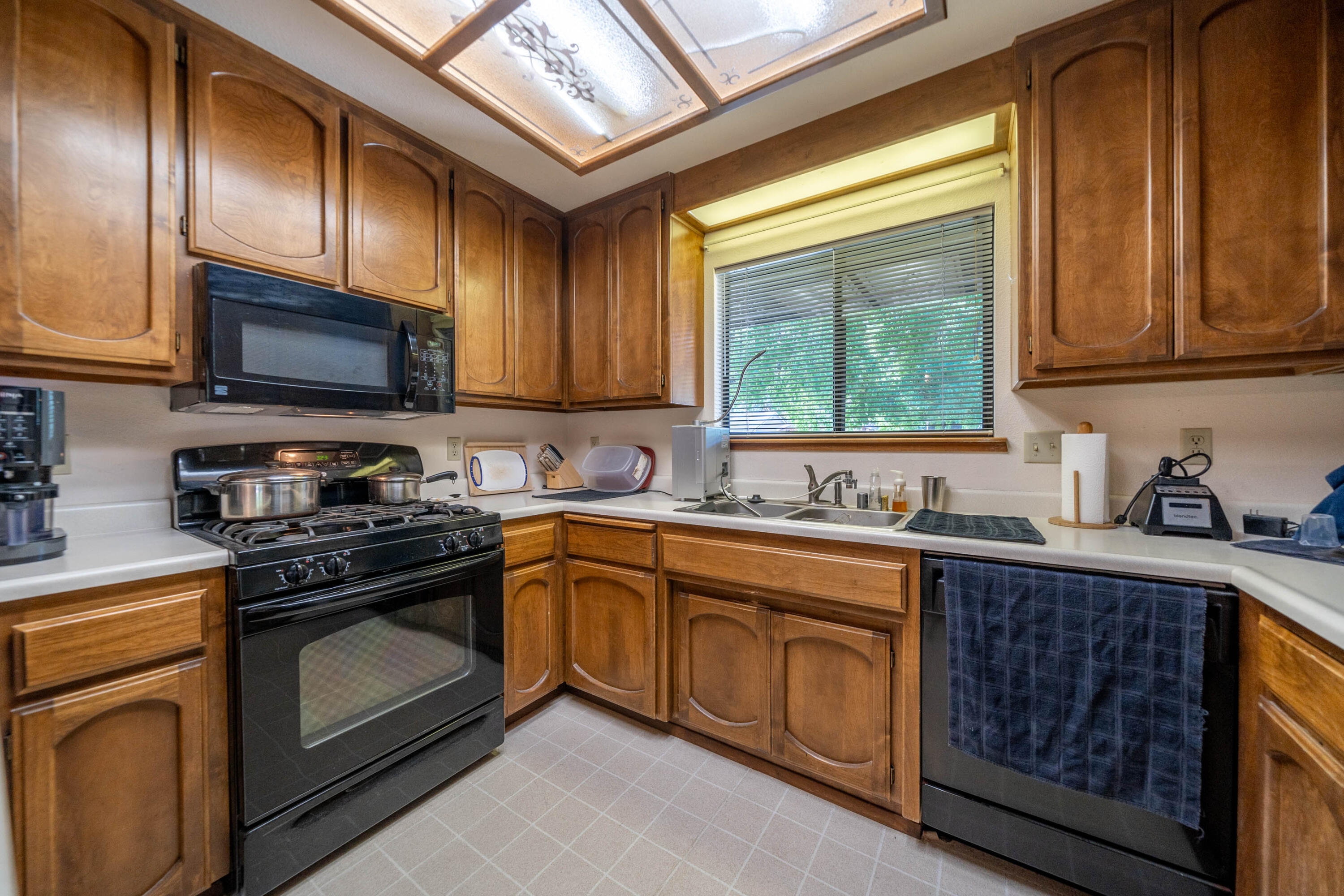 2285 Snow Lane Redding, CA 96003 - Photo 15 of 45 a kitchen with stainless steel appliances granite countertop a stove a sink dishwasher and a microwave oven with cabinets