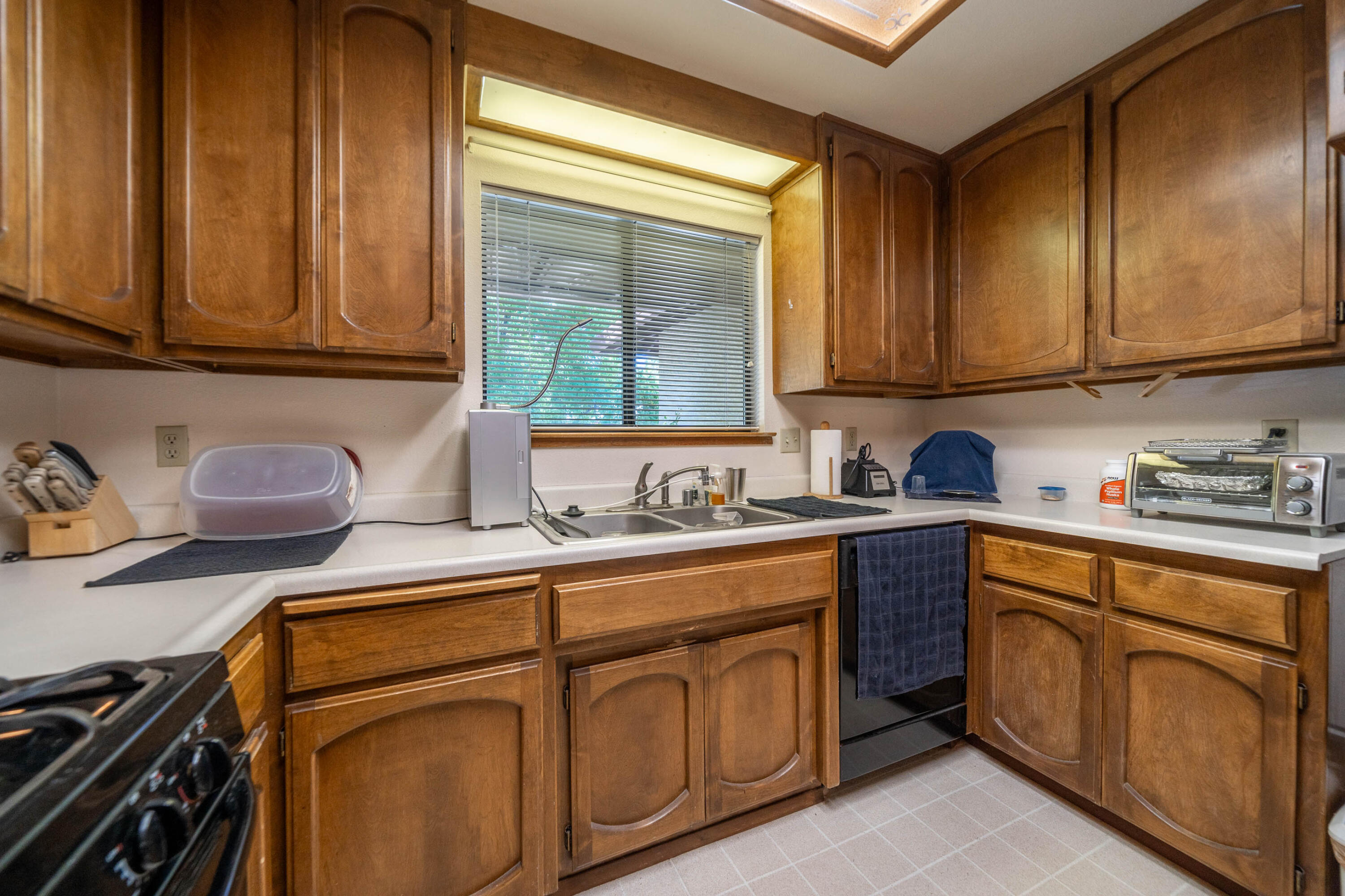 2285 Snow Lane Redding, CA 96003 - Photo 16 of 45 a kitchen with stainless steel appliances granite countertop a sink stove and cabinets