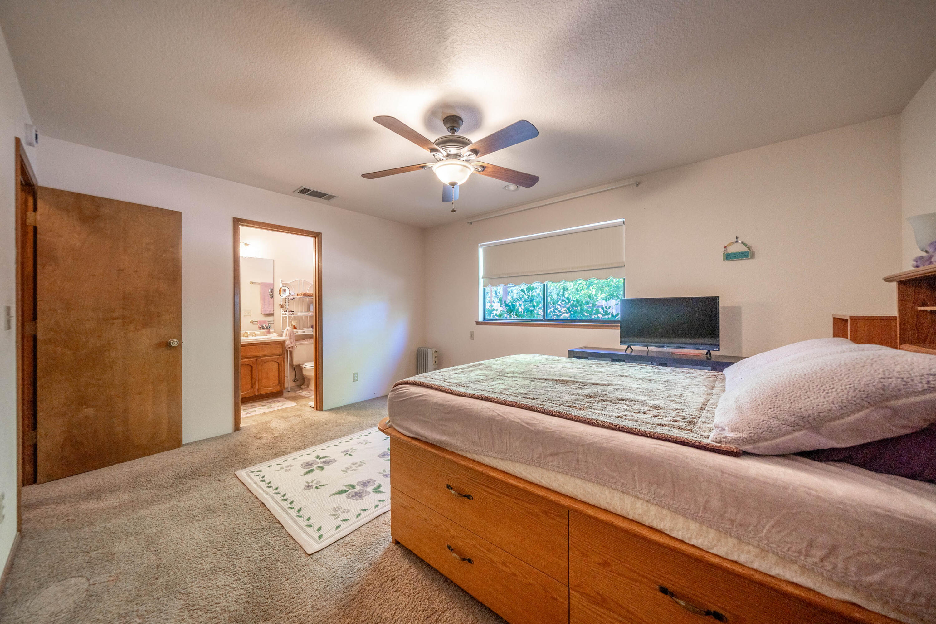 2285 Snow Lane Redding, CA 96003 - Photo 19 of 45 a bedroom with a large bed and a chandelier