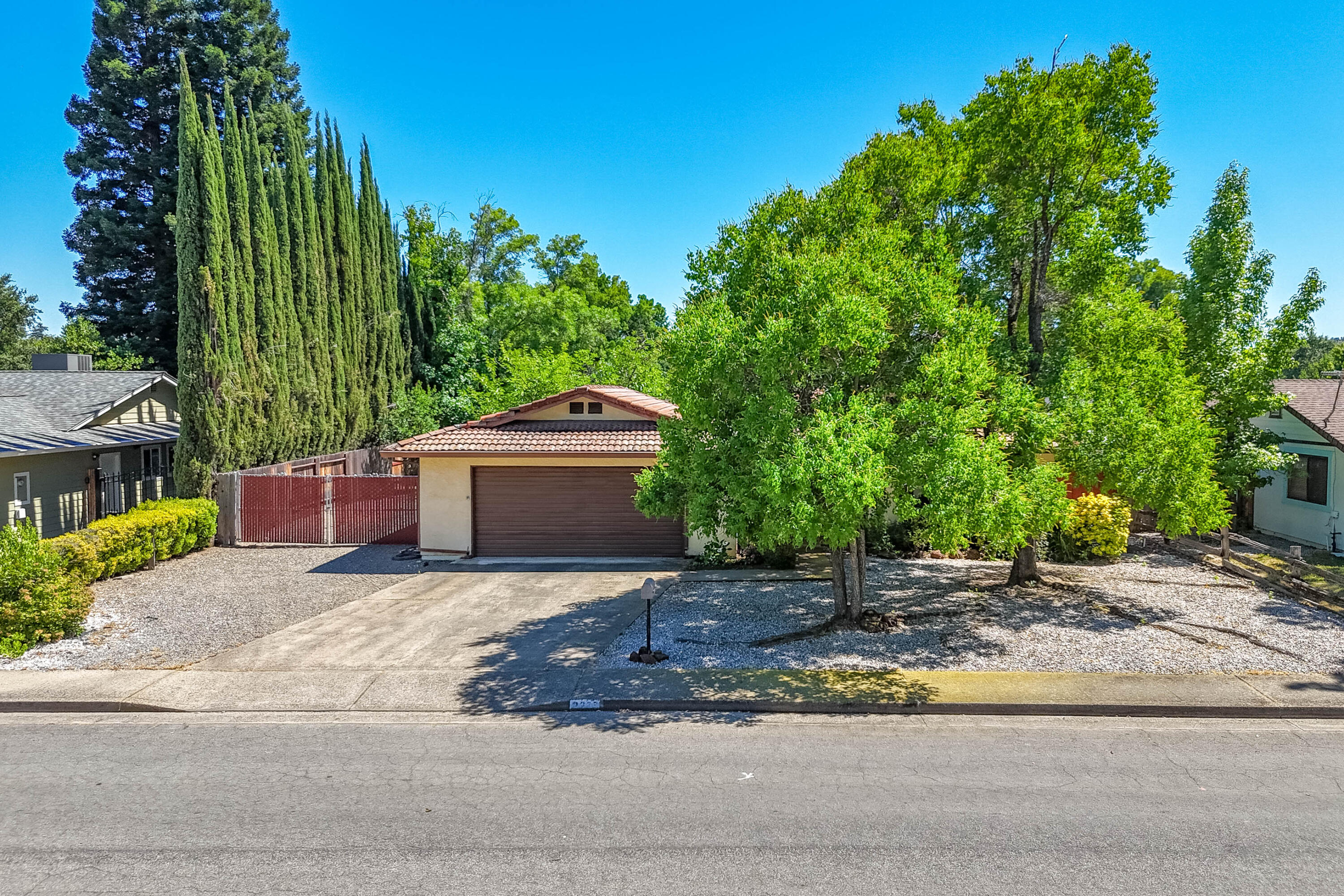2285 Snow Lane Redding, CA 96003 - Photo 3 of 45 a front view of a house with a yard and garage