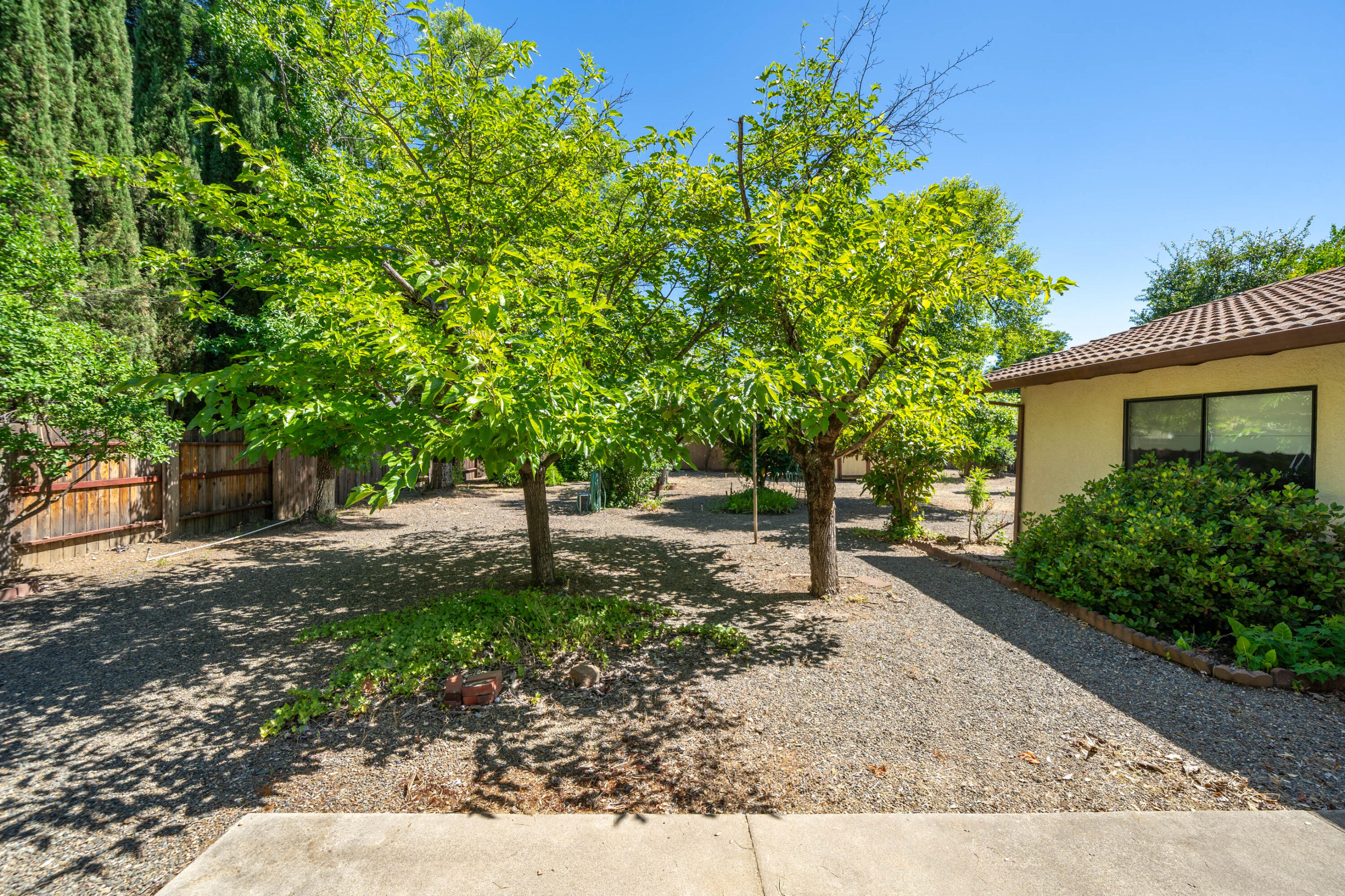 2285 Snow Lane Redding, CA 96003 - Photo 35 of 45 a backyard of a house with lots of green space