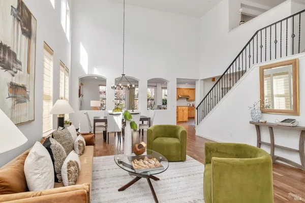 a living room with furniture and a chandelier