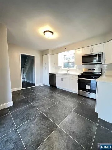 a room with a washing machine and a sink
