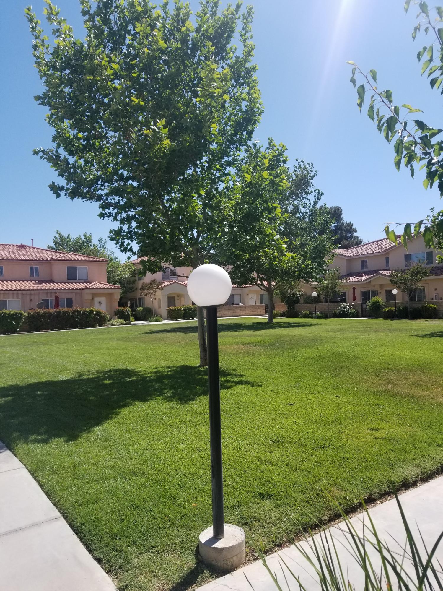 43487 30th Street West, Unit 2 Lancaster, CA 93536 - Photo 16 of 16 a front view of a house with garden