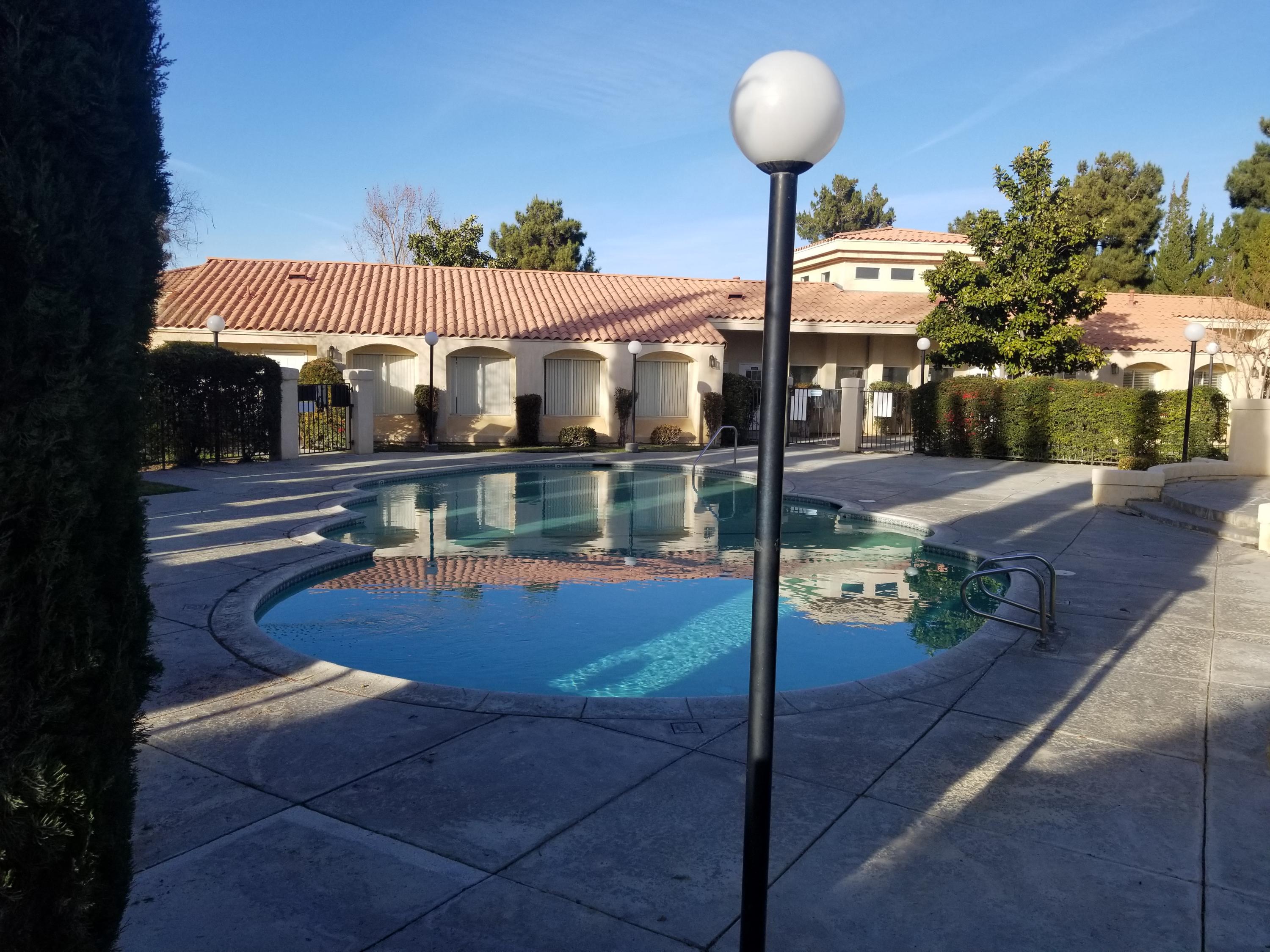 43487 30th Street West, Unit 2 Lancaster, CA 93536 - Photo 2 of 16 a view of a chairs and tables in the patio