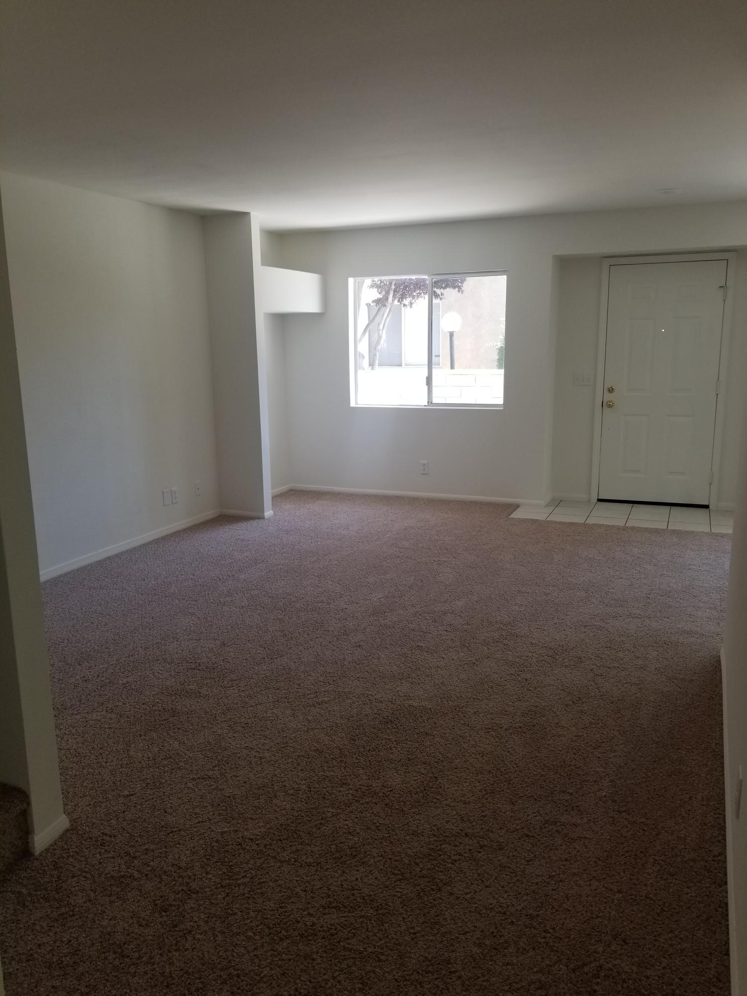43487 30th Street West, Unit 2 Lancaster, CA 93536 - Photo 3 of 16 a view of an empty room with a window