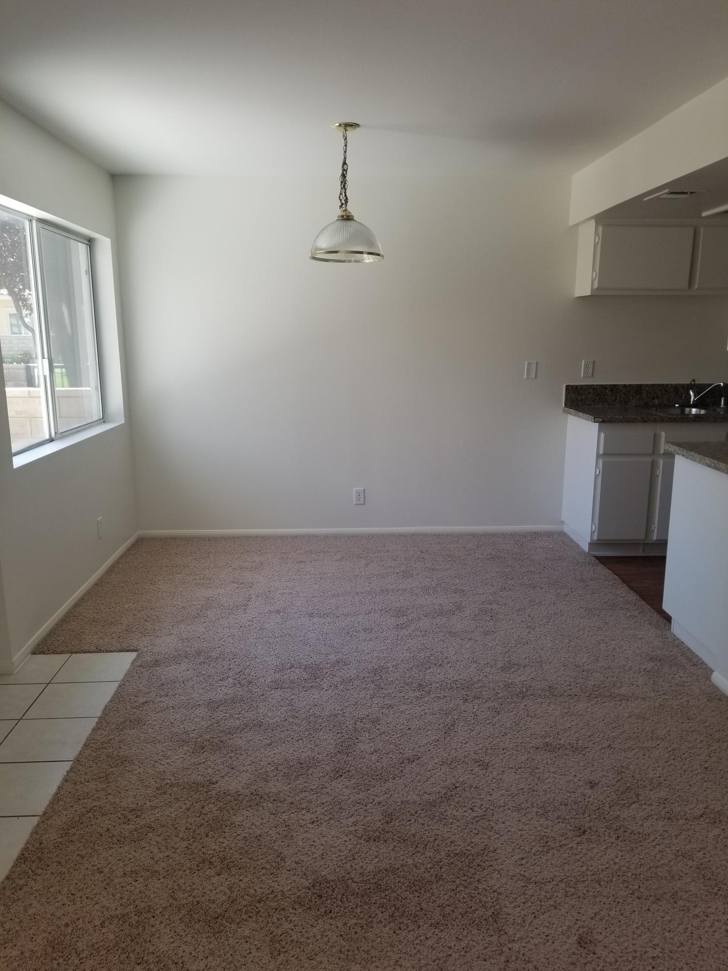 43487 30th Street West, Unit 2 Lancaster, CA 93536 - Photo 5 of 16 an empty room with windows