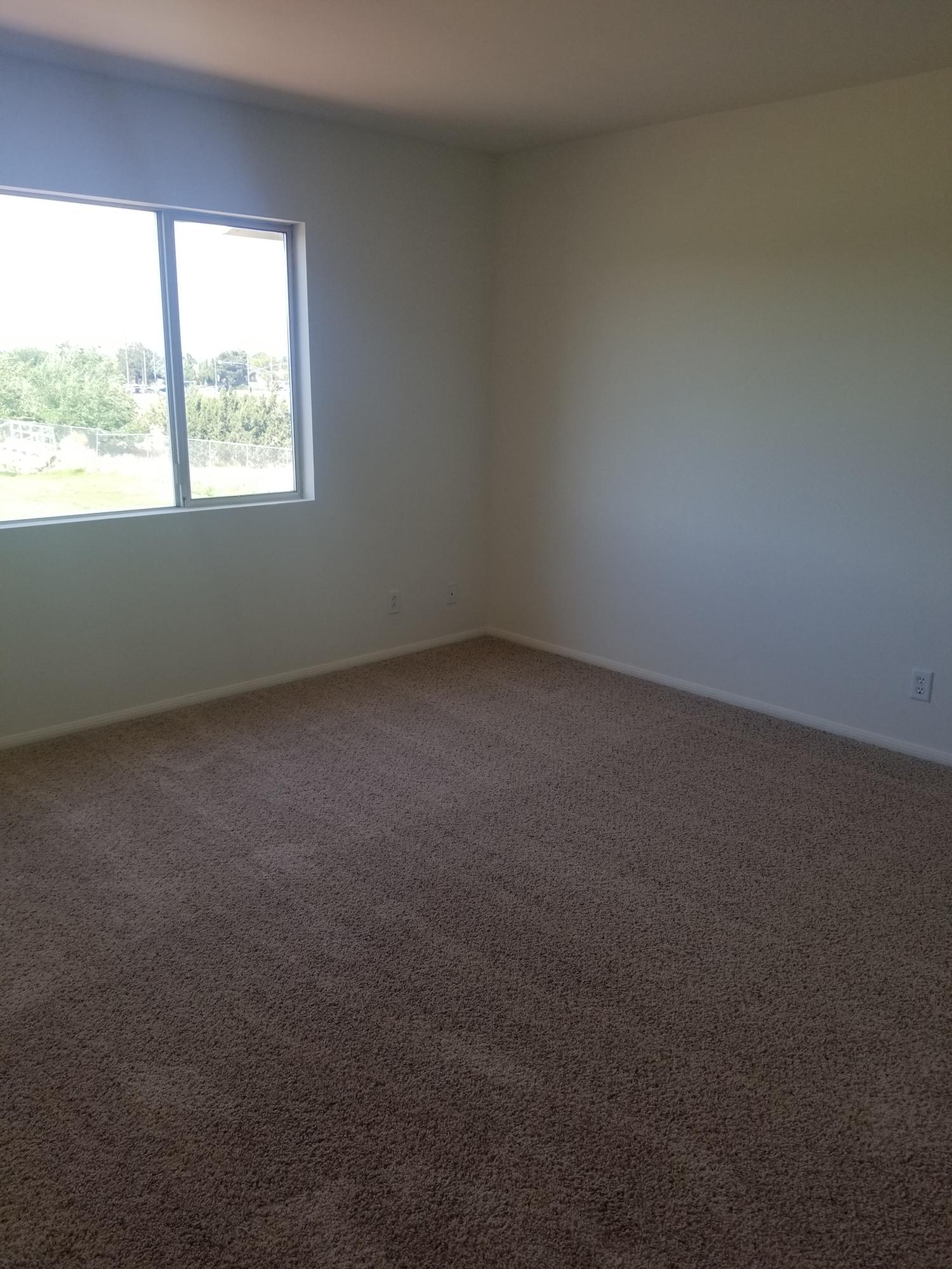 43487 30th Street West, Unit 2 Lancaster, CA 93536 - Photo 9 of 16 an empty room with a window