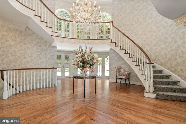 a living room with furniture fireplace and a large window