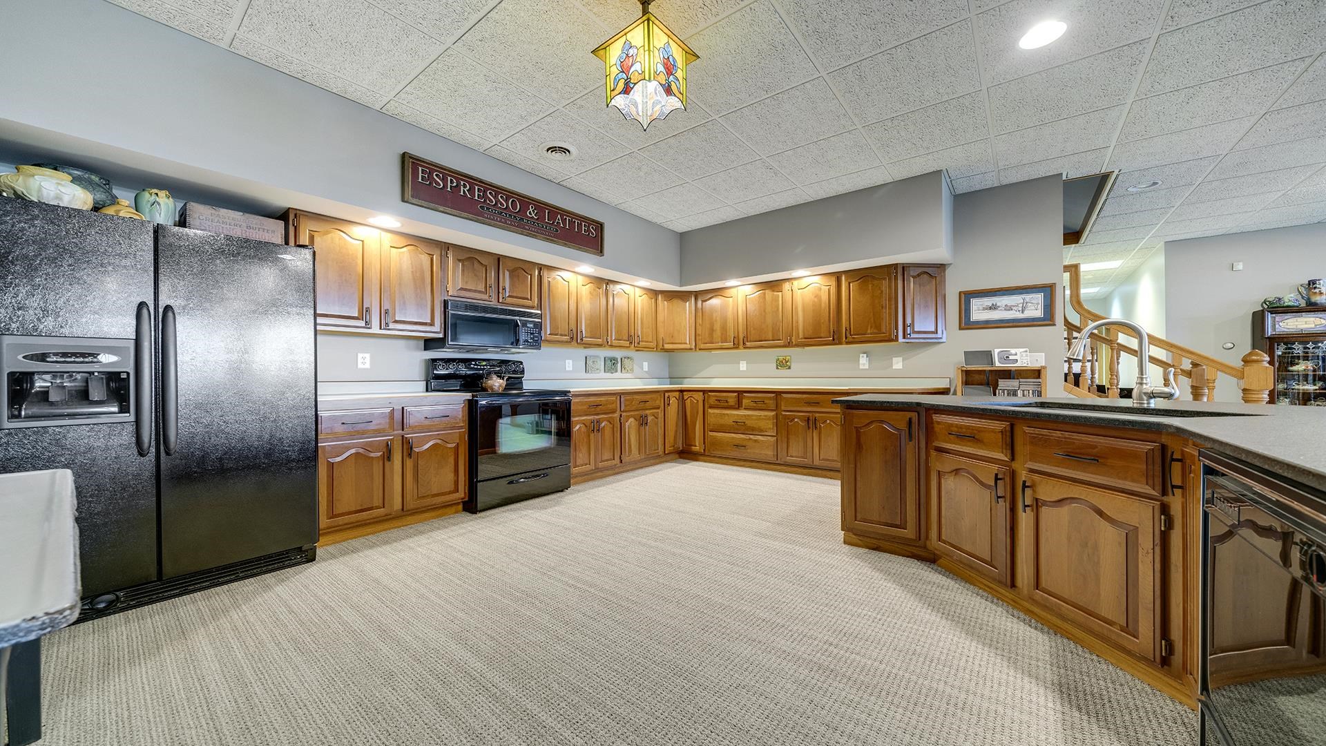 2765 West Pines Road Oregon, IL 61061 - Photo 21 of 79 a large kitchen with stainless steel appliances granite countertop a stove a sink dishwasher and a refrigerator