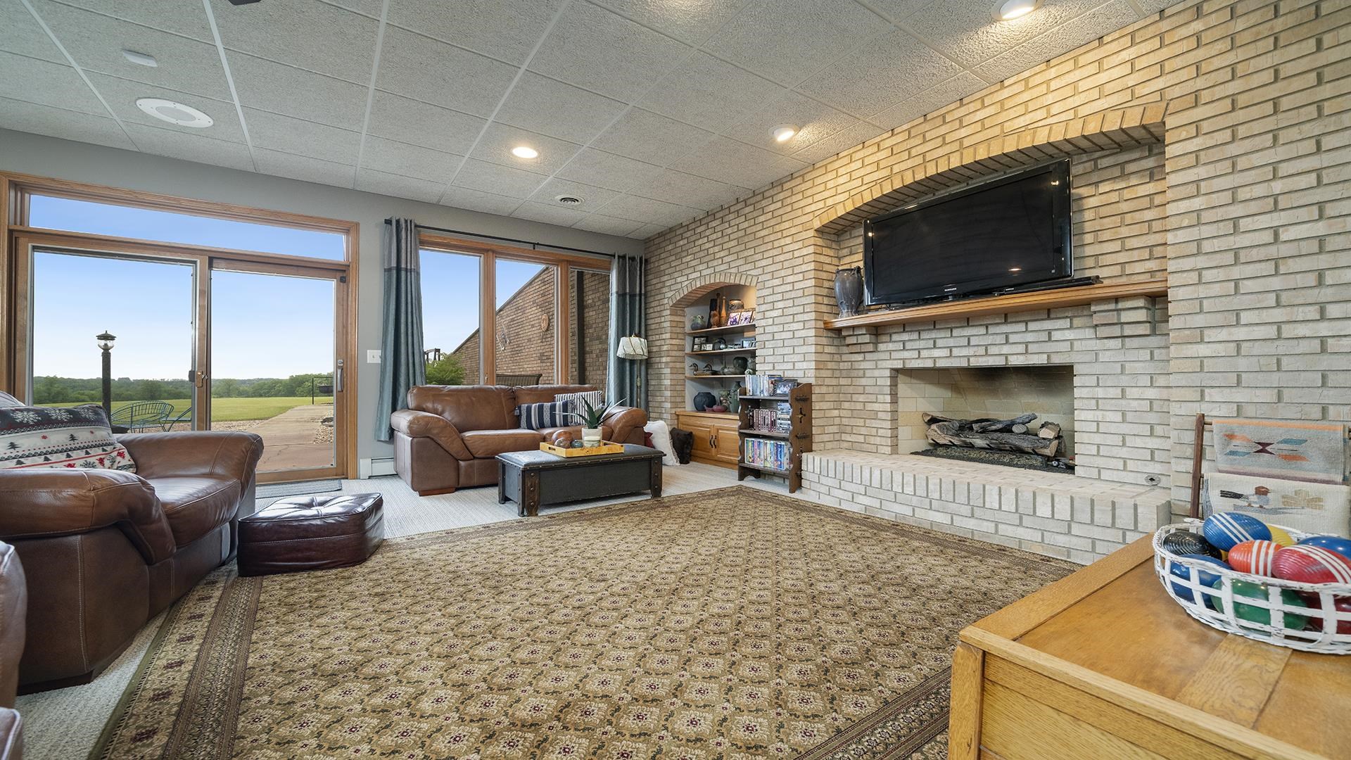 2765 West Pines Road Oregon, IL 61061 - Photo 43 of 79 a living room with furniture flat screen tv and a fireplace