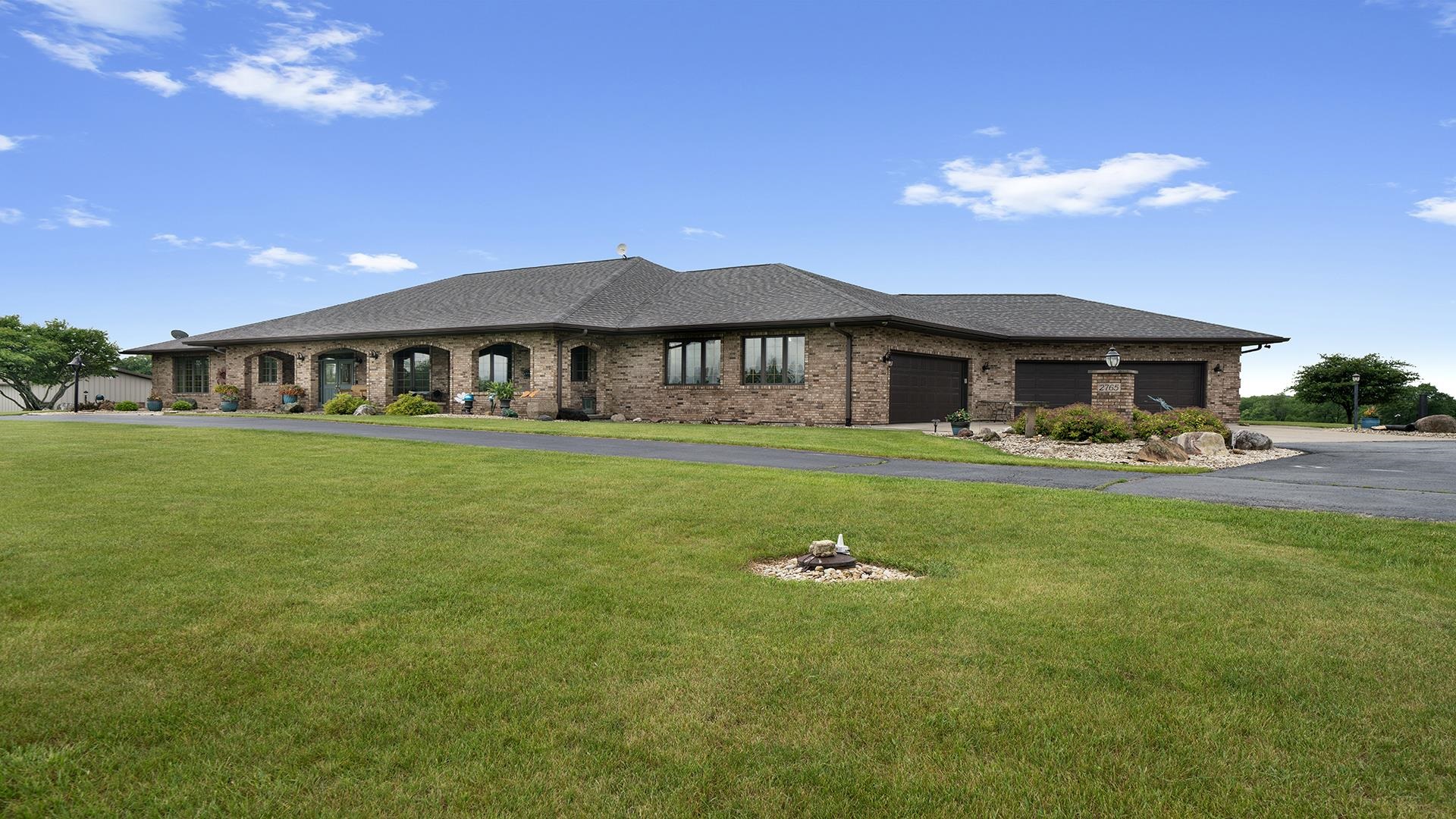 2765 West Pines Road Oregon, IL 61061 - Photo 69 of 79 a front view of a house with garden and swimming pool