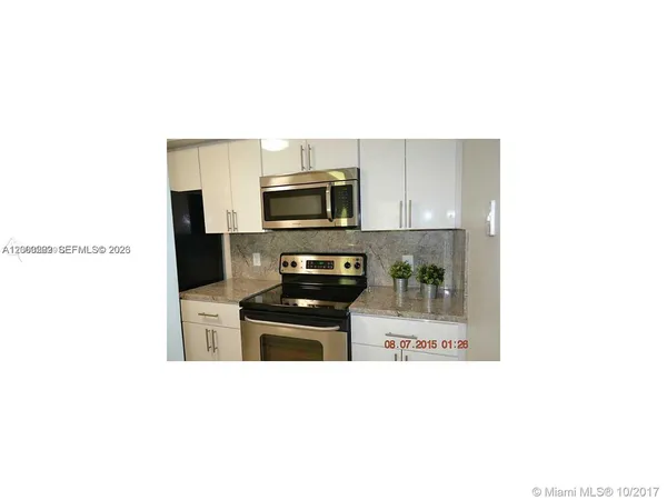 a kitchen with a sink and stainless steel appliances