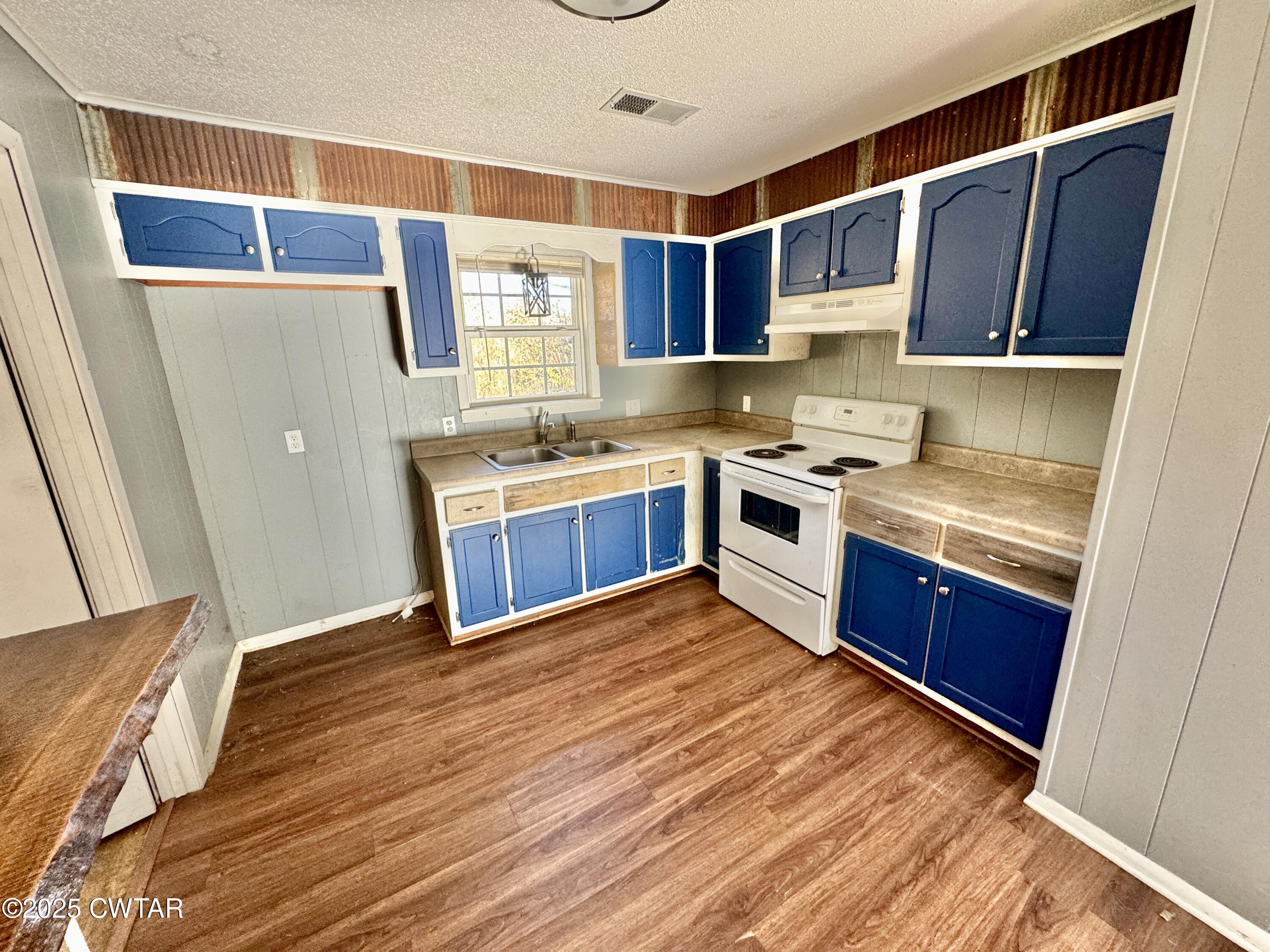 808 Barlow Road Ripley, TN 38063 - Photo 13 of 13 a kitchen with stainless steel appliances granite countertop a sink and wooden cabinets