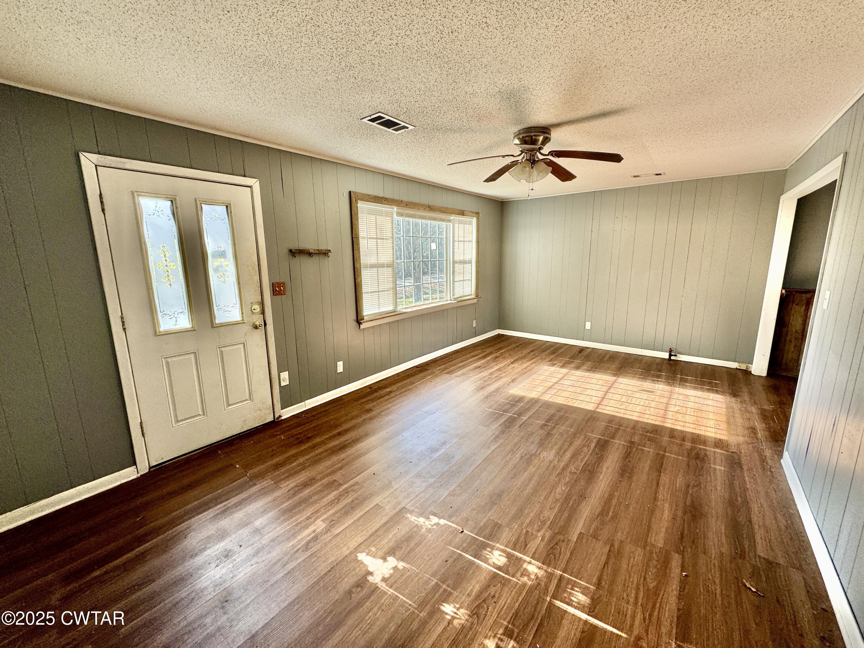 808 Barlow Road Ripley, TN 38063 - Photo 8 of 13 wooden floor in an empty room with a window