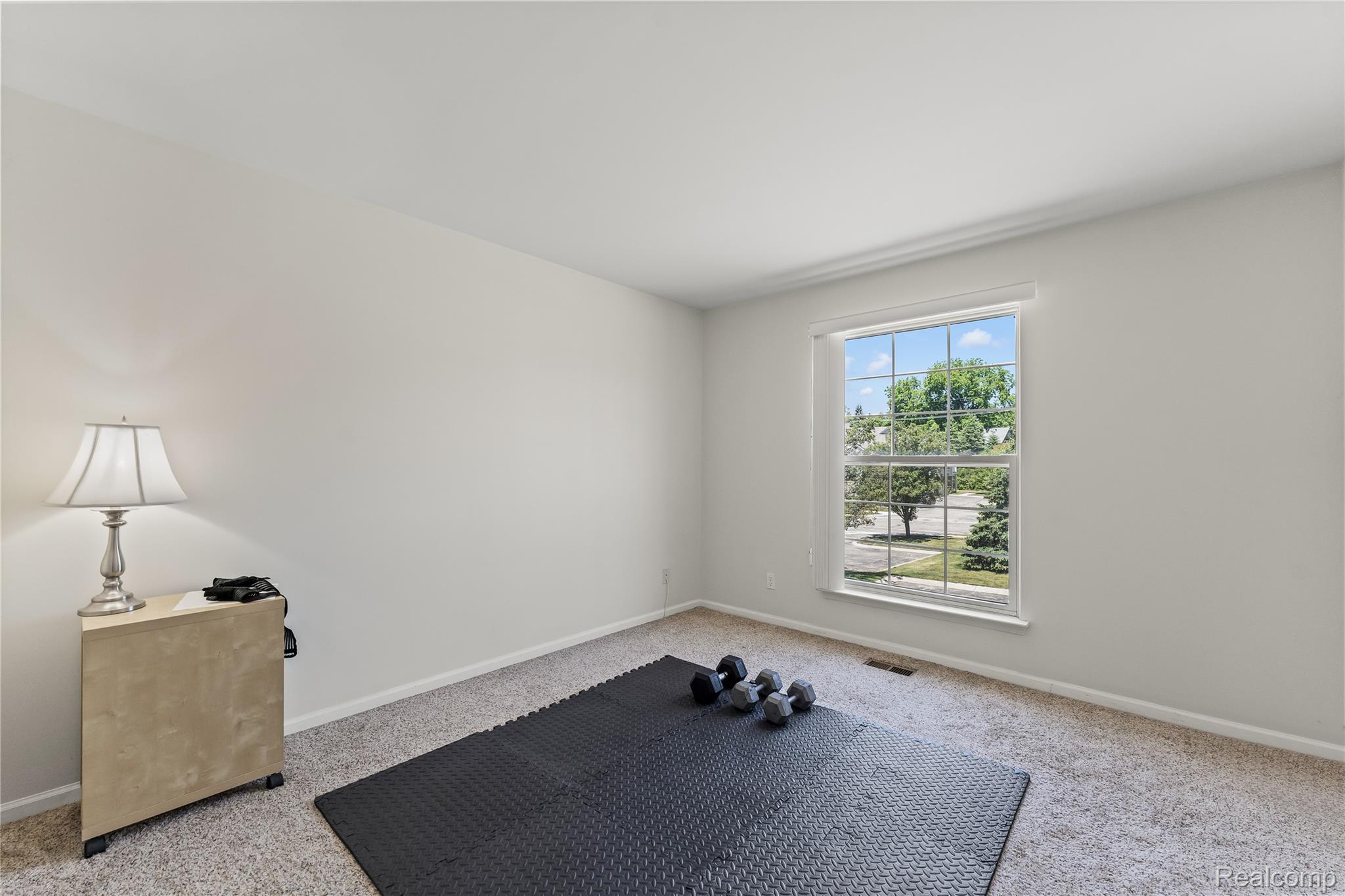 1861 Flagstone Circle Rochester, MI 48307 - Photo 12 of 21 Spacious room featuring light-toned carpeting and neutral wall paint
