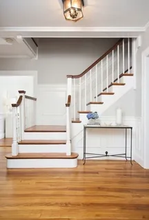 a view of entryway and hall with wooden floor