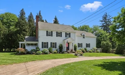 a front view of a house with a yard and porch
