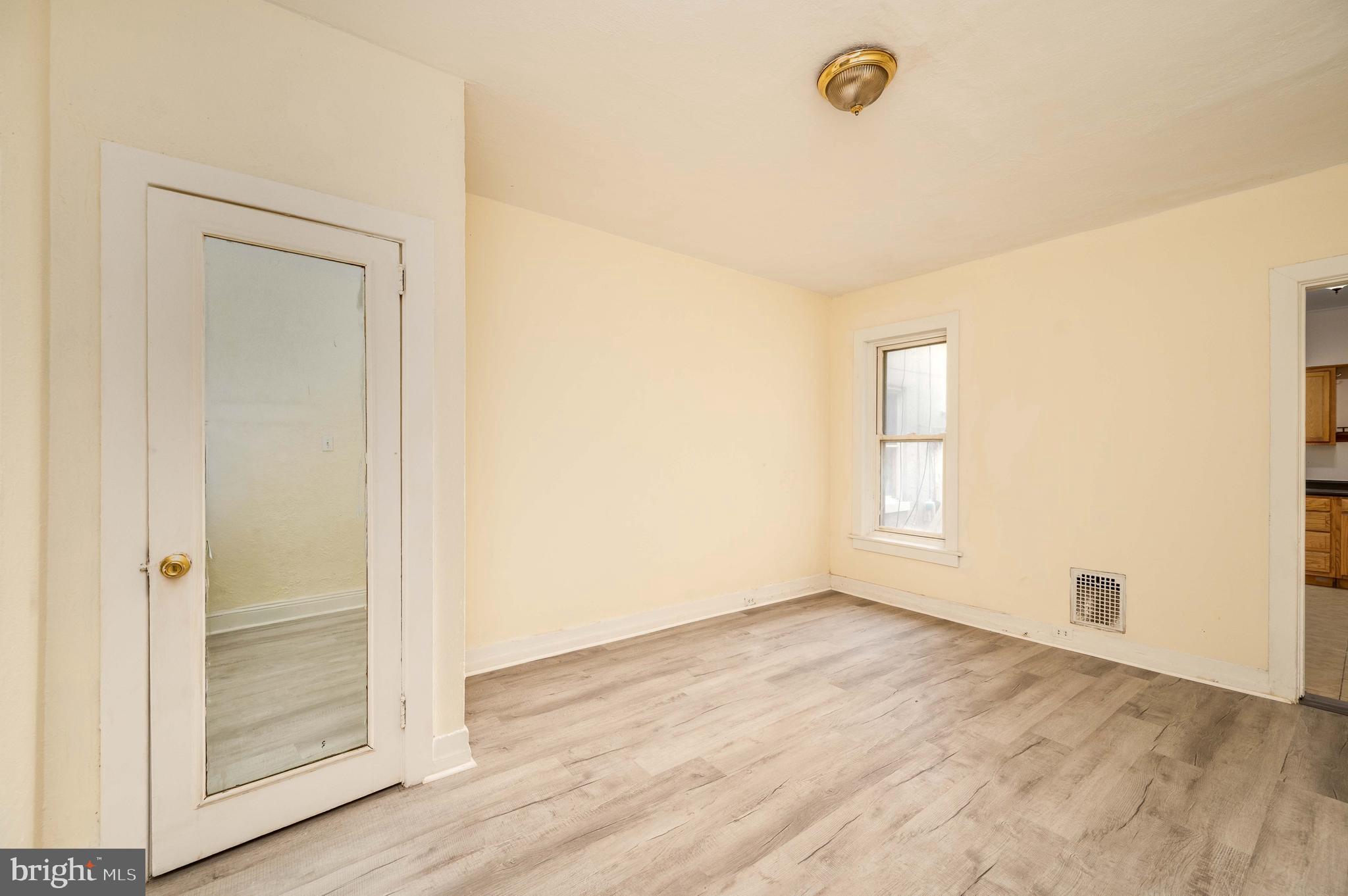 725 Madison Avenue Reading, PA 19601 - Photo 13 of 47 an empty room with wooden floor and windows