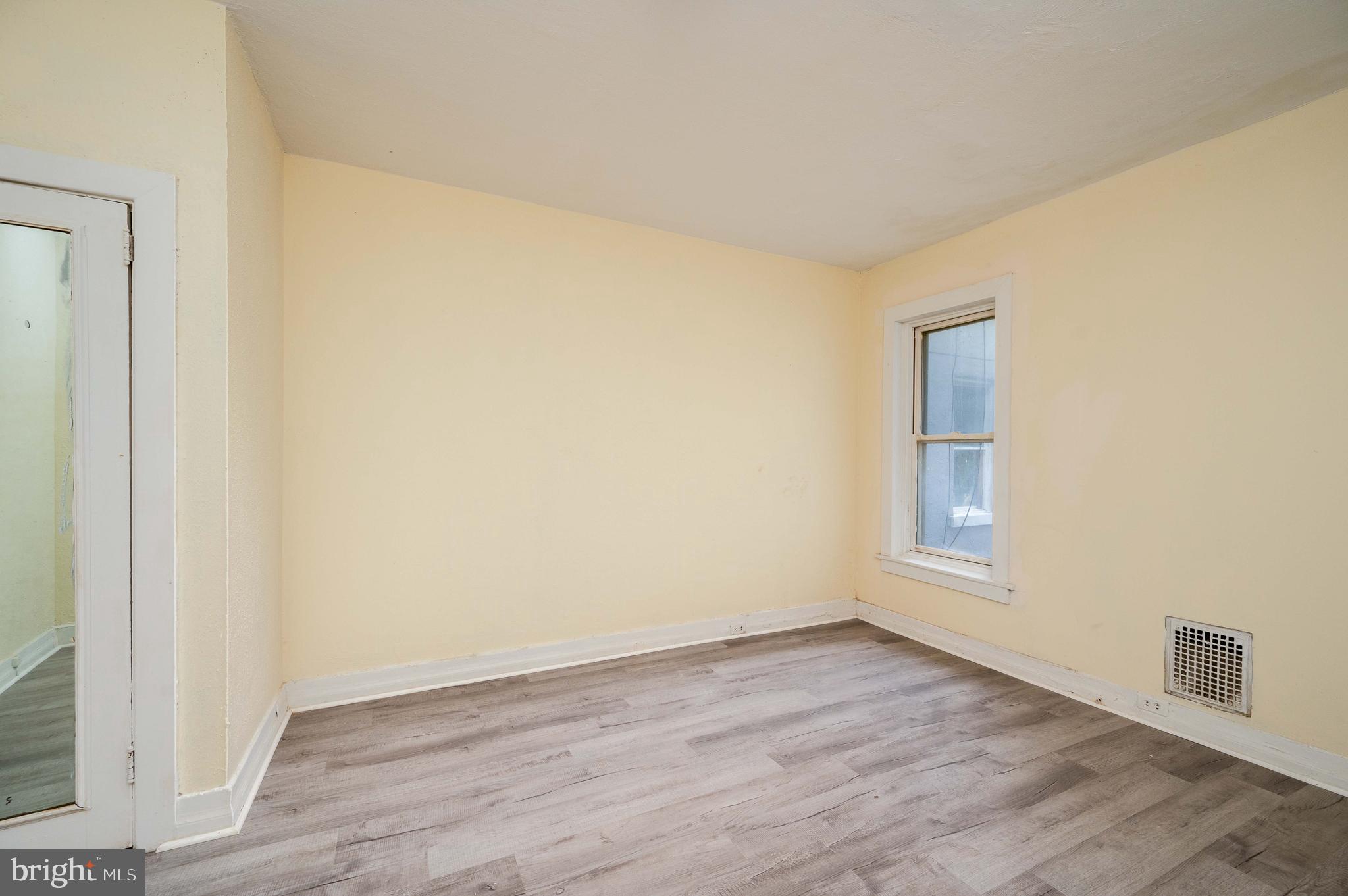 725 Madison Avenue Reading, PA 19601 - Photo 14 of 47 an empty room with wooden floor and windows