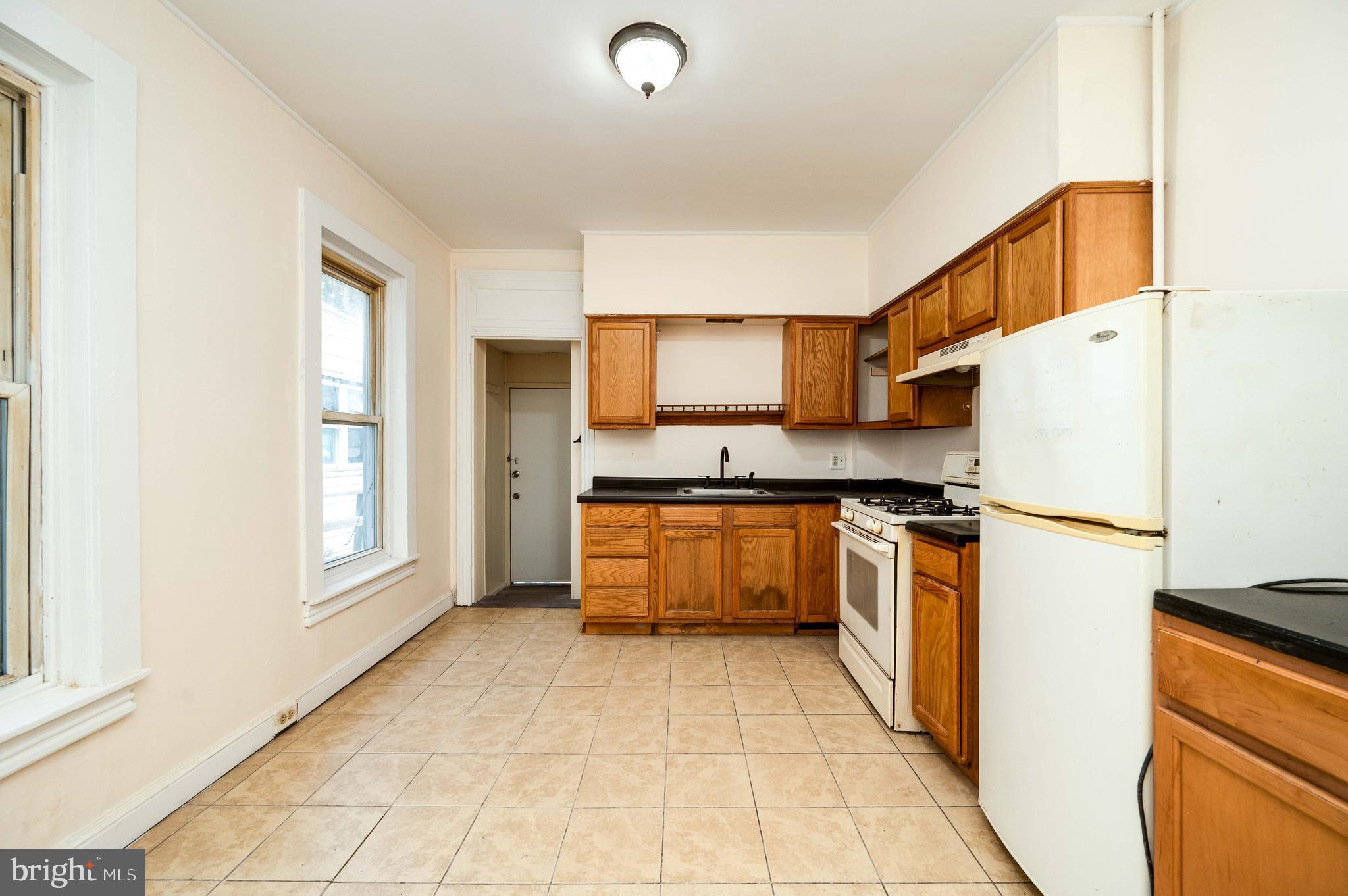 725 Madison Avenue Reading, PA 19601 - Photo 17 of 47 a kitchen with granite countertop a refrigerator and a stove top oven