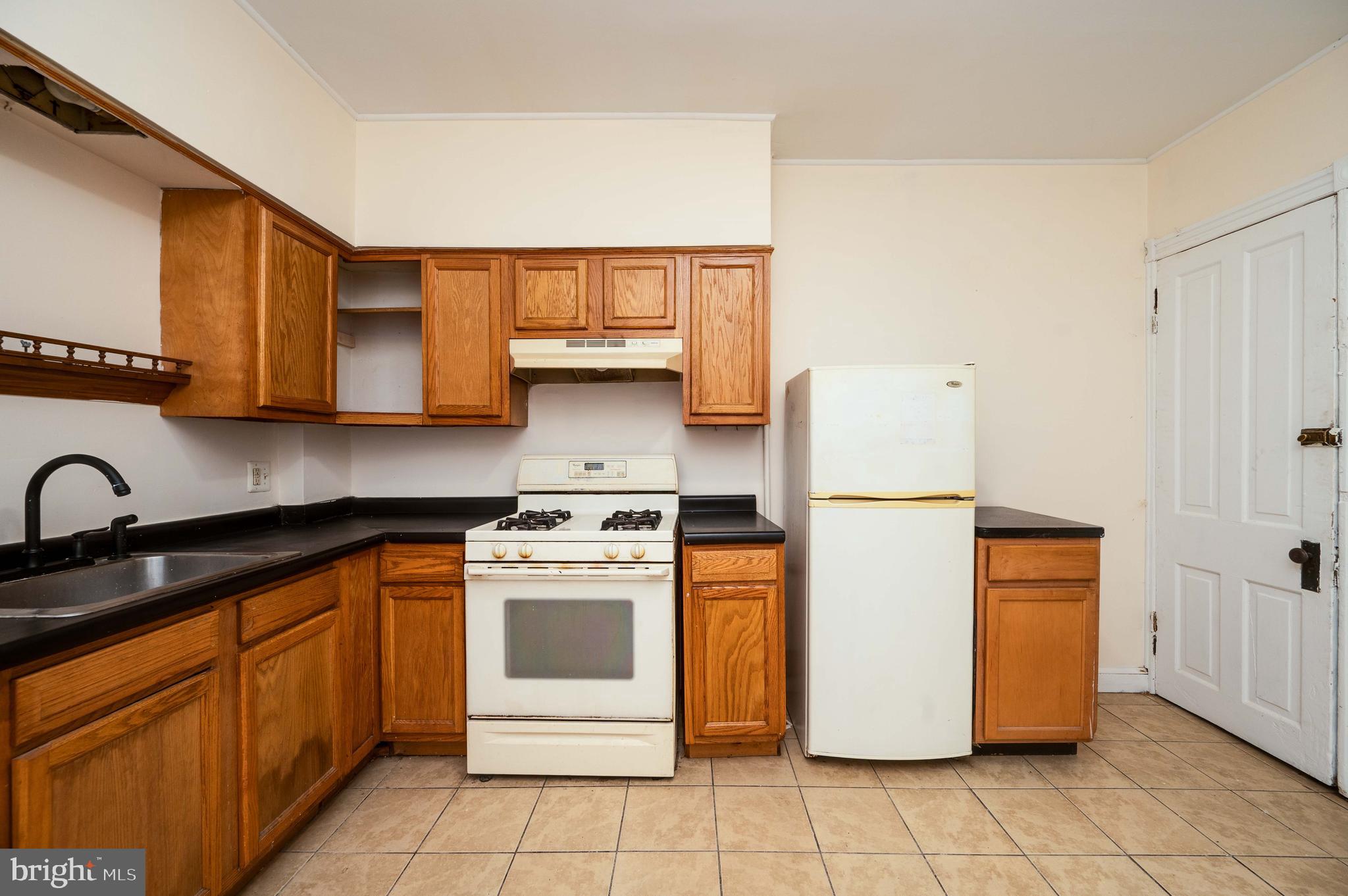 725 Madison Avenue Reading, PA 19601 - Photo 20 of 47 a kitchen with stainless steel appliances granite countertop a stove a sink and a refrigerator
