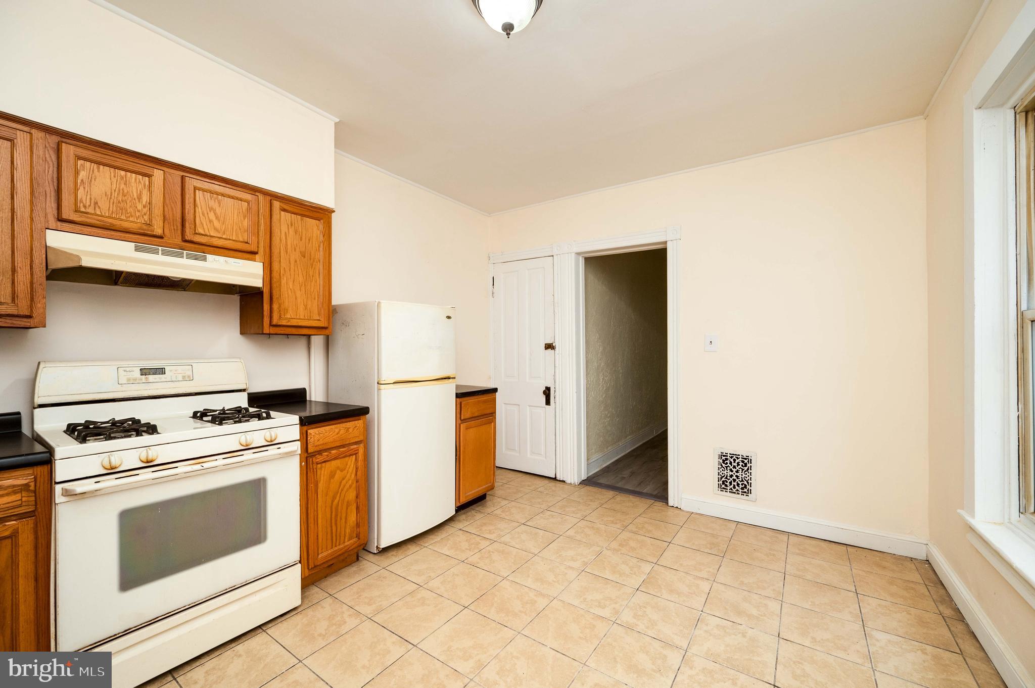 725 Madison Avenue Reading, PA 19601 - Photo 21 of 47 a kitchen with a stove top oven and cabinets