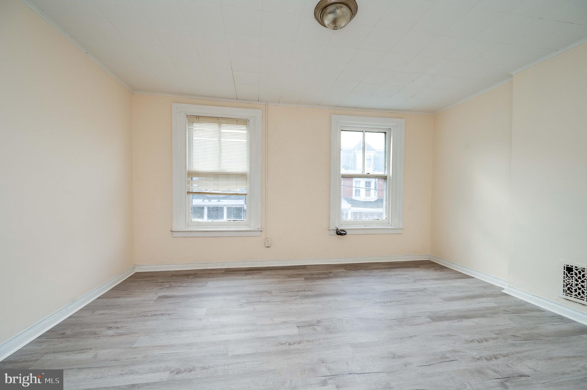 725 Madison Avenue Reading, PA 19601 - Photo 23 of 47 an empty room with wooden floor and windows