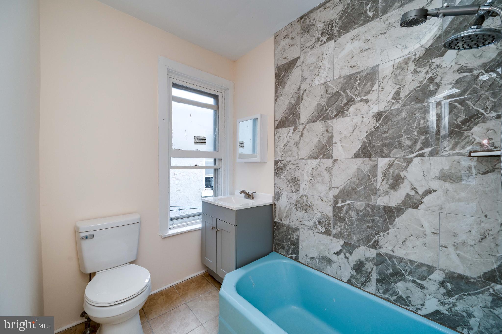 725 Madison Avenue Reading, PA 19601 - Photo 28 of 47 a bathroom with a sink a toilet and bathtub