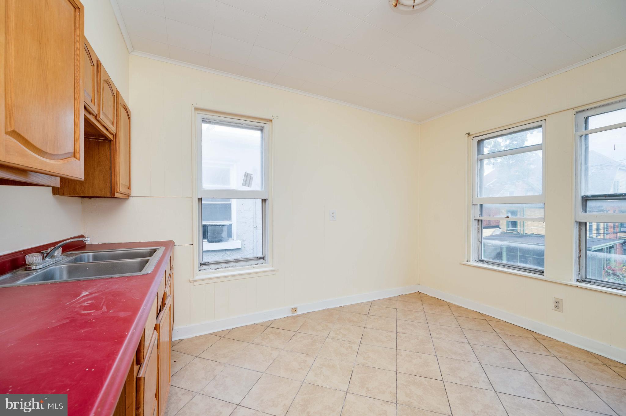 725 Madison Avenue Reading, PA 19601 - Photo 32 of 47 a kitchen with a stove a sink and a microwave