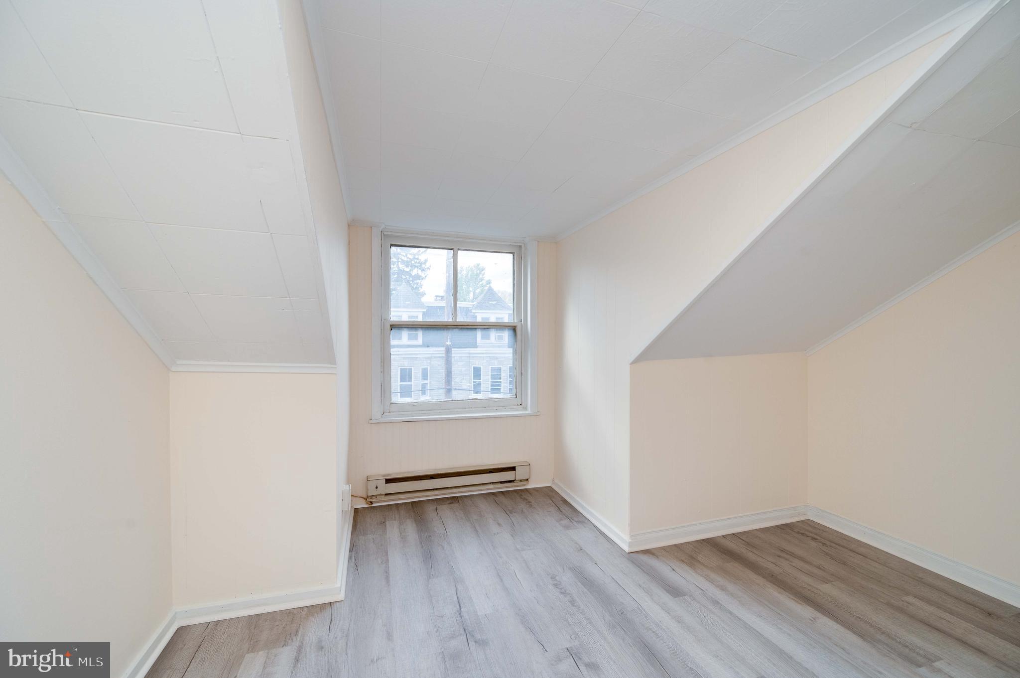 725 Madison Avenue Reading, PA 19601 - Photo 41 of 47 an empty room with wooden floor and windows