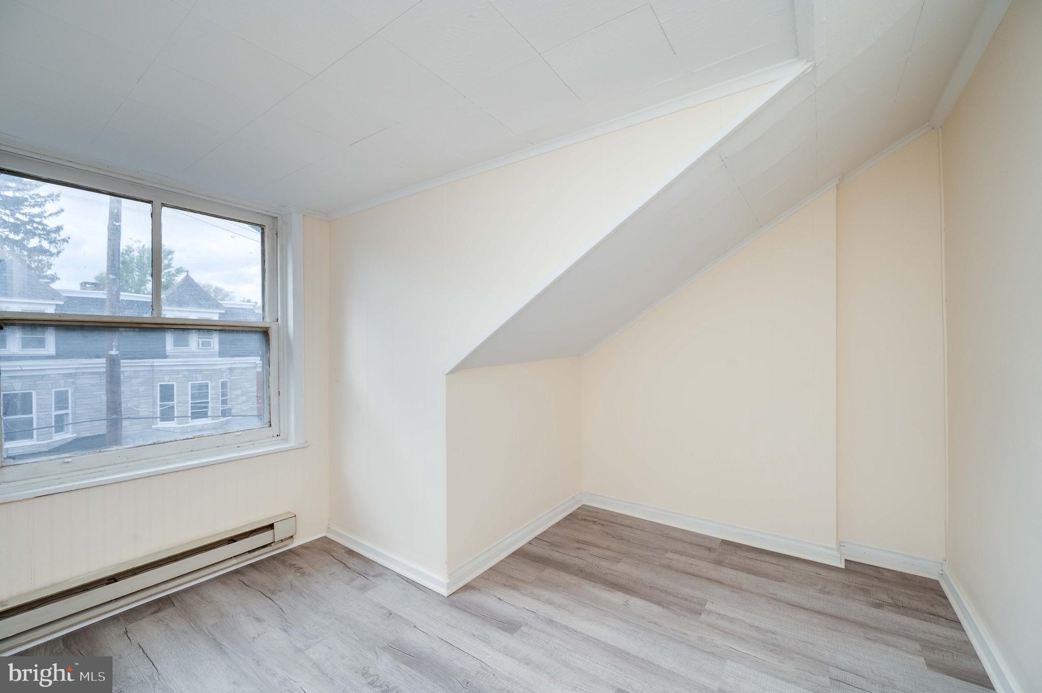725 Madison Avenue Reading, PA 19601 - Photo 42 of 47 an empty room with wooden floor and windows