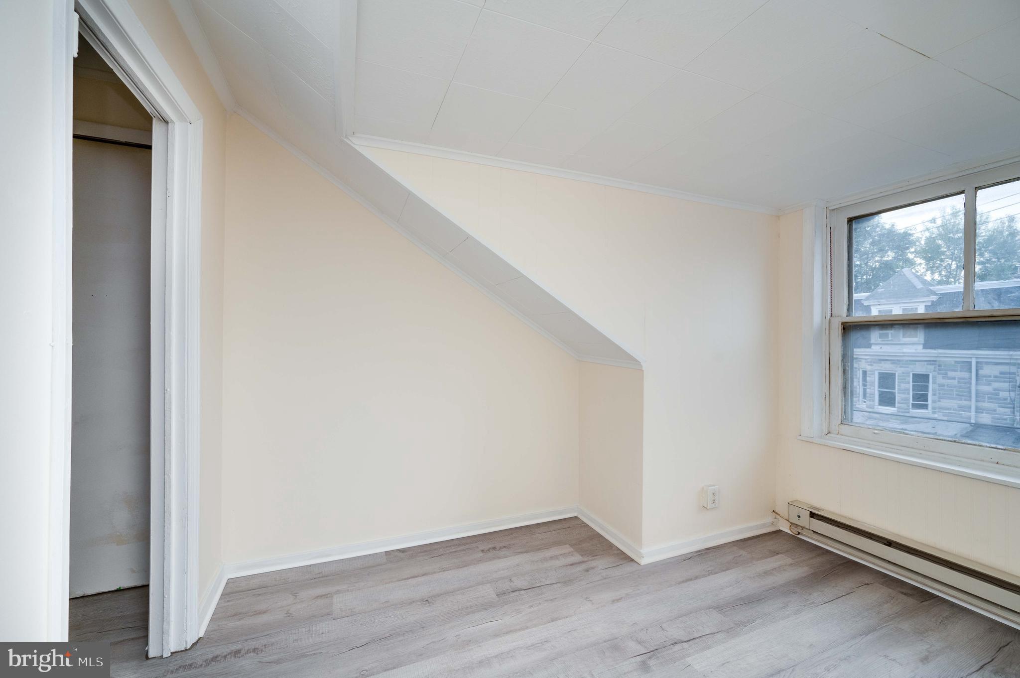 725 Madison Avenue Reading, PA 19601 - Photo 43 of 47 a view of an empty room with wooden floor and a window