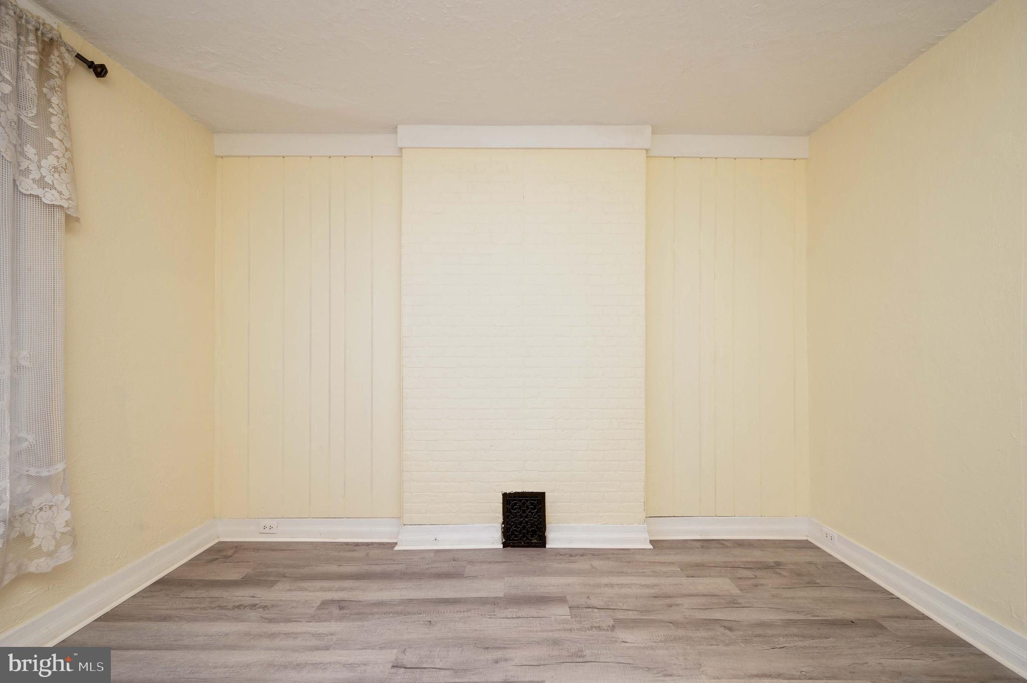 725 Madison Avenue Reading, PA 19601 - Photo 9 of 47 a view of an empty room with wooden floor and a window