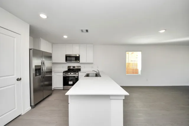 a kitchen with a sink and a refrigerator