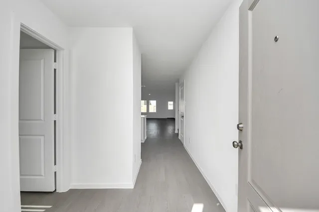 an empty room with windows and stairs