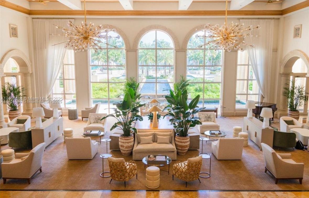 781 Crandon Boulevard, Unit 106 Key Biscayne, FL 33149 - Photo 11 of 20 a living room with patio furniture and floor to ceiling windows