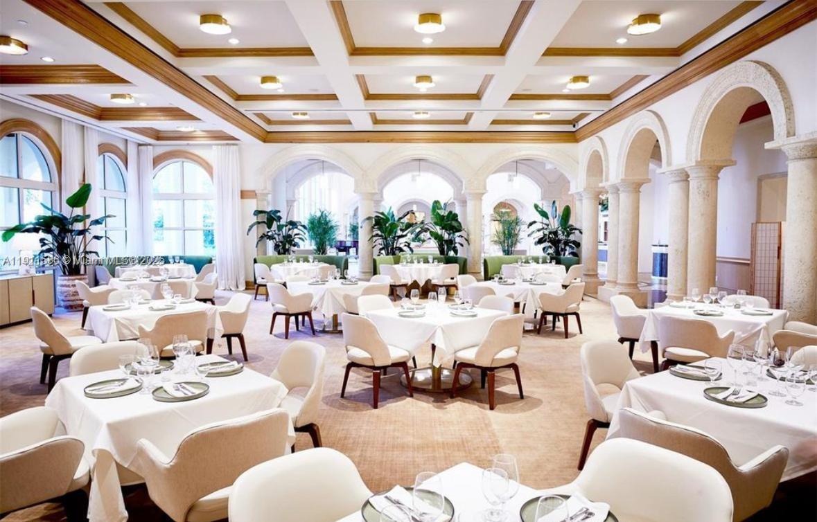 781 Crandon Boulevard, Unit 106 Key Biscayne, FL 33149 - Photo 9 of 20 a very nice looking dining room with lots of white furniture and a large window