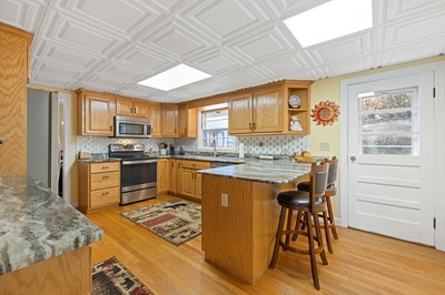 1654 Myers Chapel Road Hayesville, NC 28904 - Photo 13 of 60 a kitchen with stainless steel appliances granite countertop a stove a sink and a refrigerator