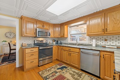 1654 Myers Chapel Road Hayesville, NC 28904 - Photo 17 of 60 a kitchen with stainless steel appliances granite countertop wooden cabinets a sink and dishwasher a stove top oven with wooden floor
