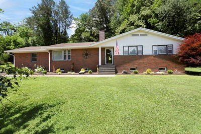 1654 Myers Chapel Road Hayesville, NC 28904 - Photo 59 of 60 a view of house with yard and trees in the background