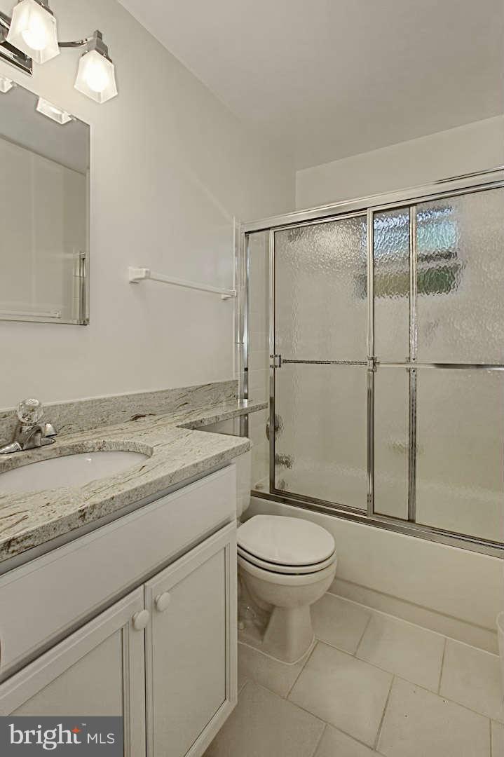 7006 Spaniel Road Springfield, VA 22153 - Photo 22 of 29 a bathroom with a granite countertop sink toilet and shower