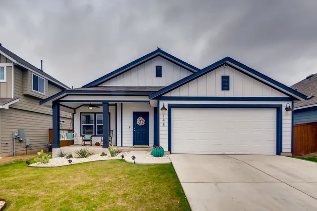 a view of a house with large windows and yard