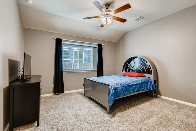 a bedroom with a bed and flat screen tv